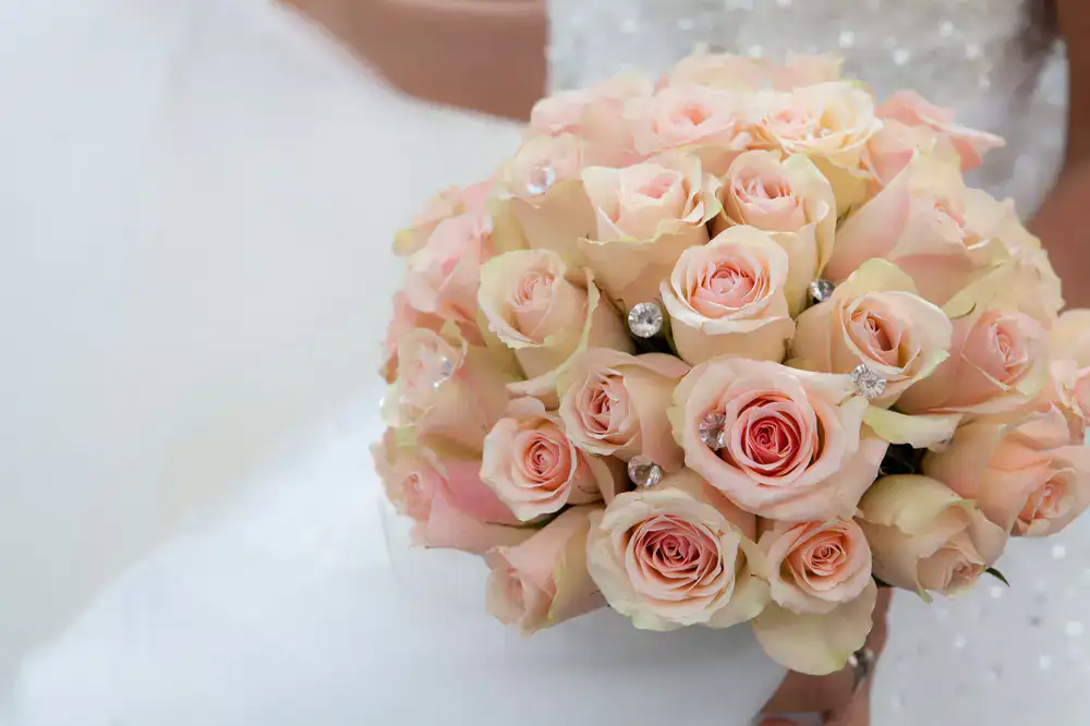 A lush romantic bouquet featuring dusty rose and cream flowers